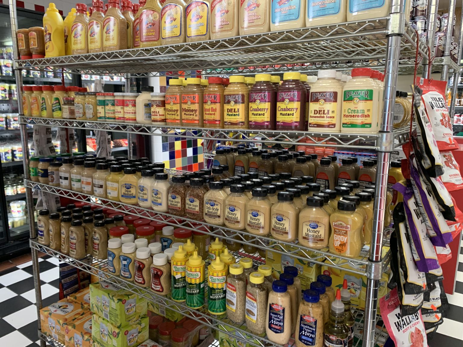 Racks of different sauces in Cecils Deli